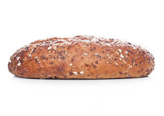 Freshly baked  loaf of bread with oats on white