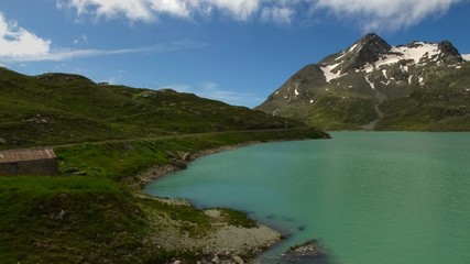 panoramic image of the Bernina red train network with lake and mountains