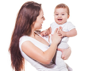 Pretty mother tickling baby