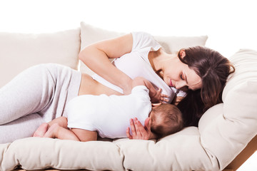 loving mother is playing with the baby