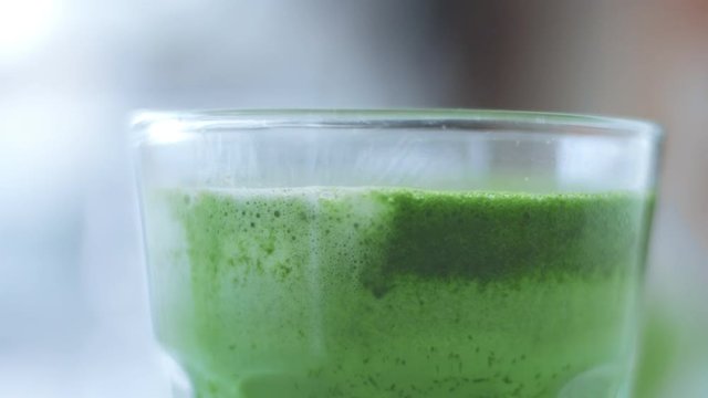 panned video of glass with matcha latte closeup