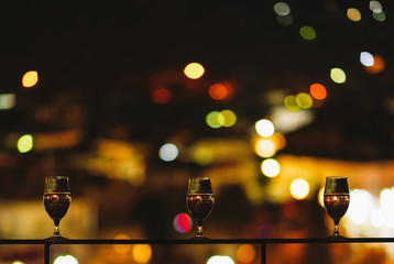 glass of wine on a balcony on the background of a night city