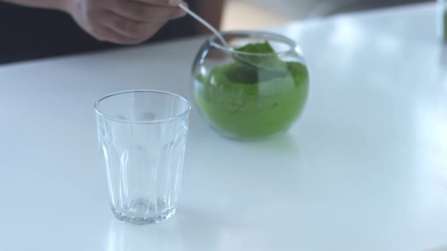 man put some spoons of matcha in glass