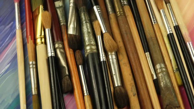Various paintbrushes on the background of sketches