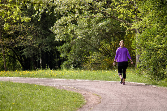 lonely lady walking on path, training in the nature