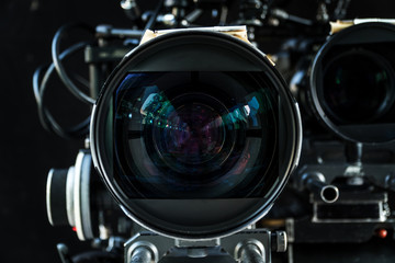Close up shot of cinema lens with lot of equipment for filming cinema or movie in a division...