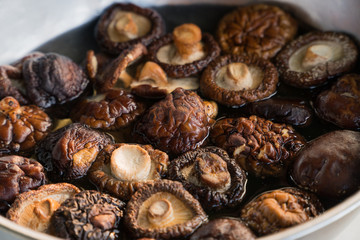 Shiitake mushroom soaking water in a bowl.