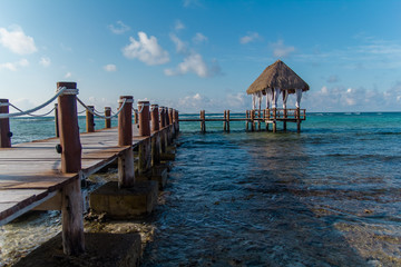 A wooden dock on the Caribbean Sea in Mexico, Yucatan. Waves