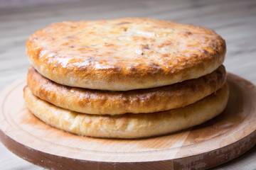 Traditional Ossetian pies. Three basic pies for the holiday. Close-up, selective focus.