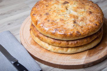 Traditional Ossetian pies. Three basic pies for the holiday. Close-up, selective focus.