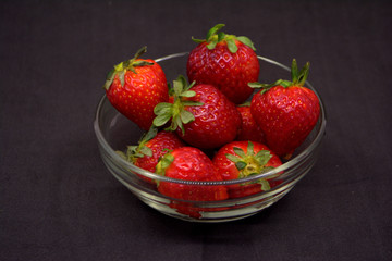 strawberry in a plate on a black background