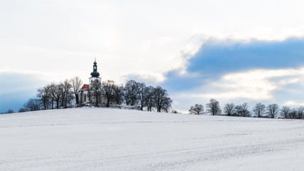 Church in idyllic winter landscape. Kostelec, South Bohemia, Europe. Artistic scene with chapel on...
