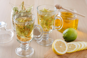 herbal tea with lemon and honey in a glass on a dark light background