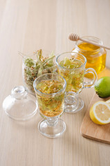 herbal tea with lemon and honey in a glass on a dark light background