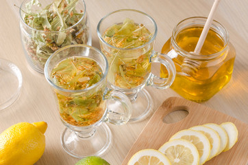herbal tea with lemon and honey in a glass on a dark light background