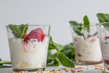 seasonal strawberries with cream and mint in glass cup