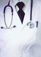 Medical doctor with a stethoscope standing in office