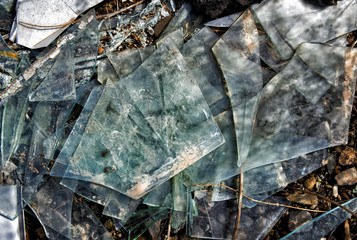 Many broken pieces of glass. Shattered and splitted glass Pieces. Glass texture. Abstract background