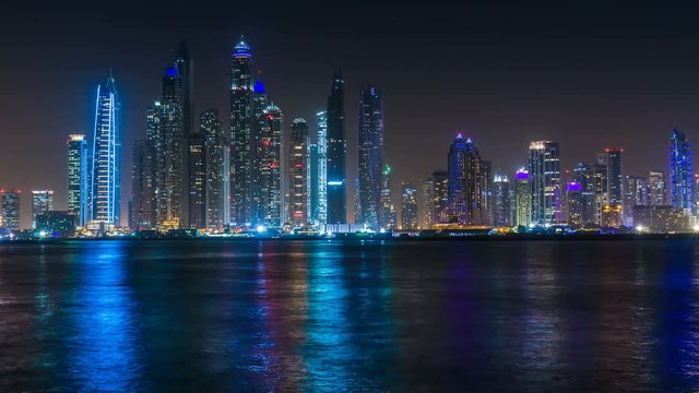 Beautiful view of Dubai Marina Towers, night skyline, View from Palm Jumeirah, time lapse, United Arab Emirates.