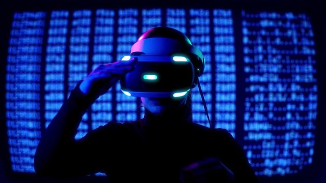 Young female in VR Headset controls virtual reality by hand gestures in front of computer barcode moving background. Future tech concept