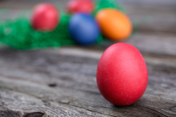 different easter eggs on gray wooden ground