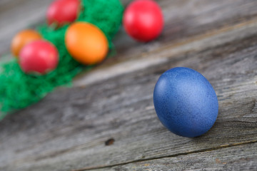 Fototapeta na wymiar different easter eggs on gray wooden ground
