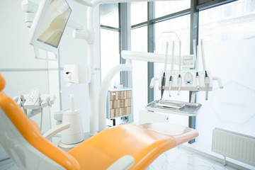 Contemporary equipment for dental check-up with armchair for patient near by