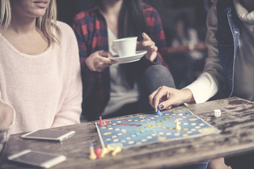 Fototapeta premium Young three girls play together a social game. Focus on hand.