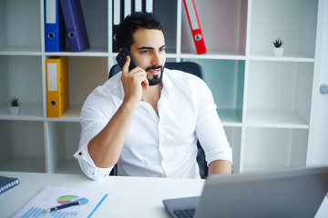 Handsome Businessman Working on Laptop at His Office