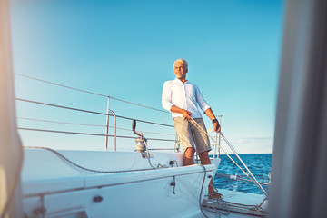 Mature man out for a sail on his boat