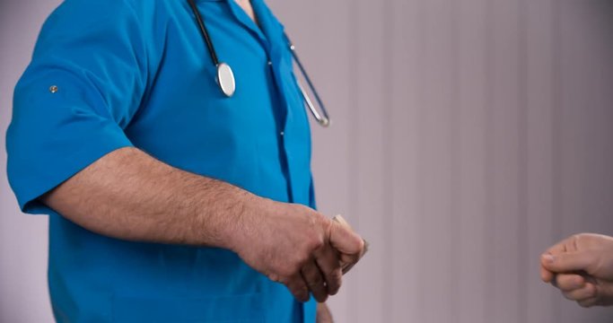 doctor taking bribes from patients
