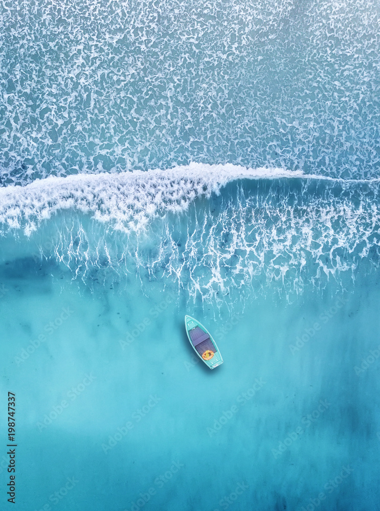 Wall mural wave and boat on the beach as a background. beautiful natural background at the summer time from air