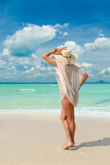 Naklejka na ściany i meble woman sunbathing on the tropical beach