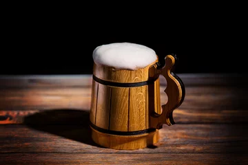 Foto op Canvas Mug with beer on the old wooden table © Taranukhin Alex