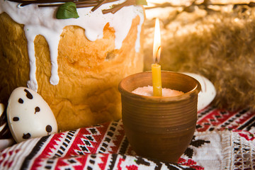 Easter pie in eco-style decorated in the form of a nest with eggs on the background of the national traditional towel