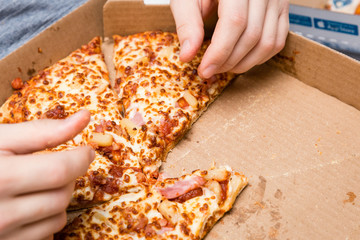 close up of  pizza in a cardboard box