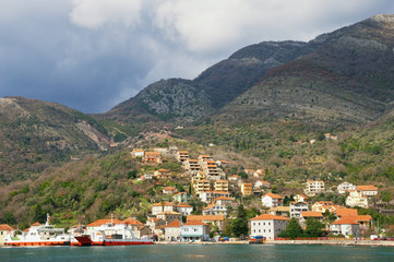 Fototapeta na wymiar Winter Mediterranean landscape with village on a mountainside. Montenegro, Bay of Kotor, Kamenari
