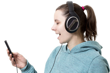 Young girl in headphones with player in hands listening to pop music isolated on white background. woman listens to modern music. Singing in headphones with player. Music hobby and sounds.