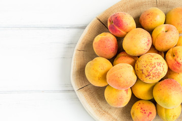 Fresh apricots on white wooden table. Flat lay, top view