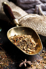 Spices for cooking with kitchen accessories on an old background