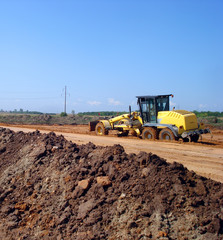 Obraz premium Grader adjust elevation level soil for construction site