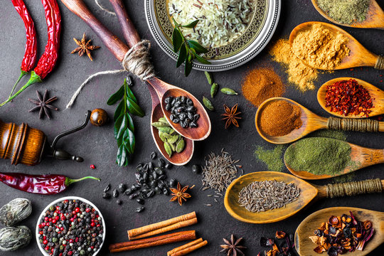 Spices For Cooking With Kitchen Accessories On An Old Background