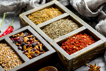 Spices for cooking with kitchen accessories on an old background