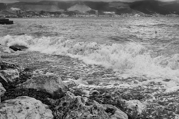 Coastal waves break on stones. Black Sea, Novorossiysk, Russia