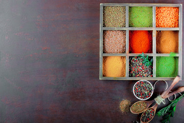 Spices for cooking with kitchen accessories on an old background