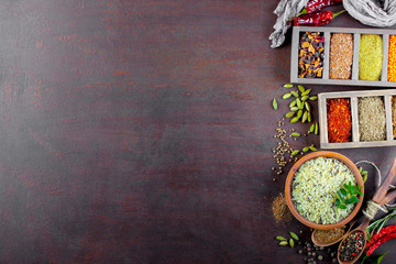 Spices for cooking with kitchen accessories on an old background