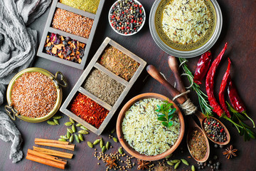 Spices for cooking with kitchen accessories on an old background
