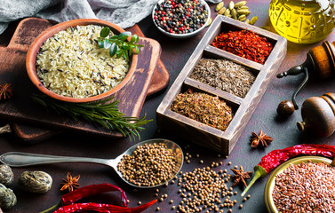 Spices for cooking with kitchen accessories on an old background