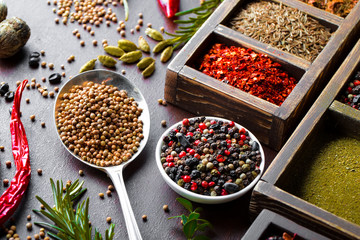 Spices for cooking with kitchen accessories on an old background
