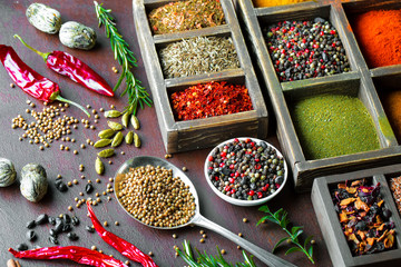 Spices for cooking with kitchen accessories on an old background